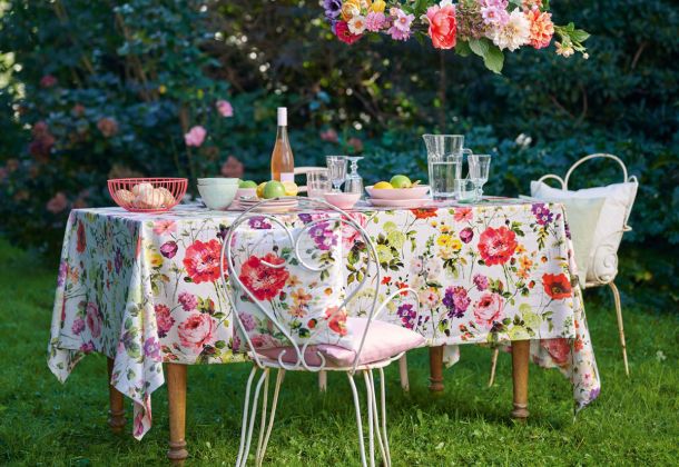 Gedeckter Tisch im Garten mit Blumendeko